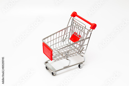 Toy shopping cart. Toy shopping trolley on white background.