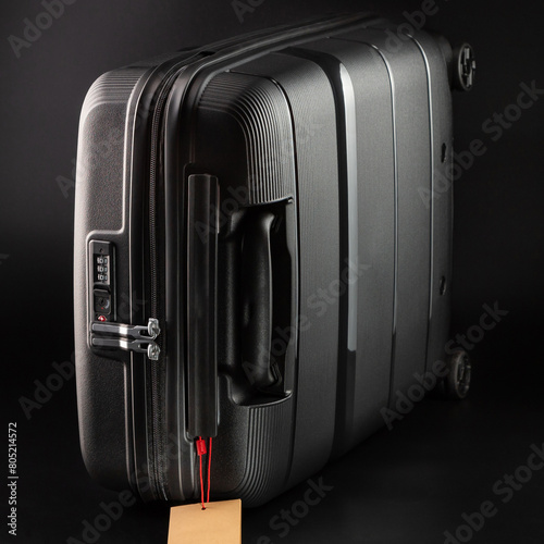 Carry-on suitcase on a black background