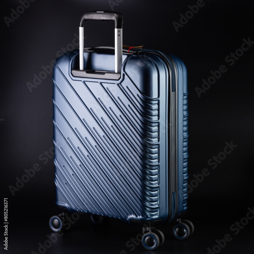 Carry-on suitcase on a black background