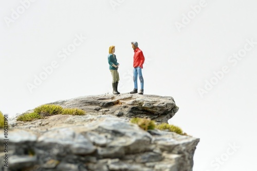 A couple of people standing on top of a rock. Suitable for outdoor adventure or teamwork concepts
