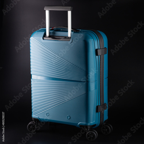 Carry-on suitcase on a black background