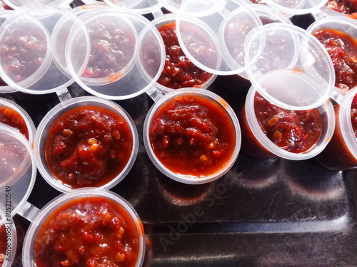 sauce with shrimp. a bunch of chili paste in a plastic cup. Chili shrimp paste. food background. Sambal terasi photo