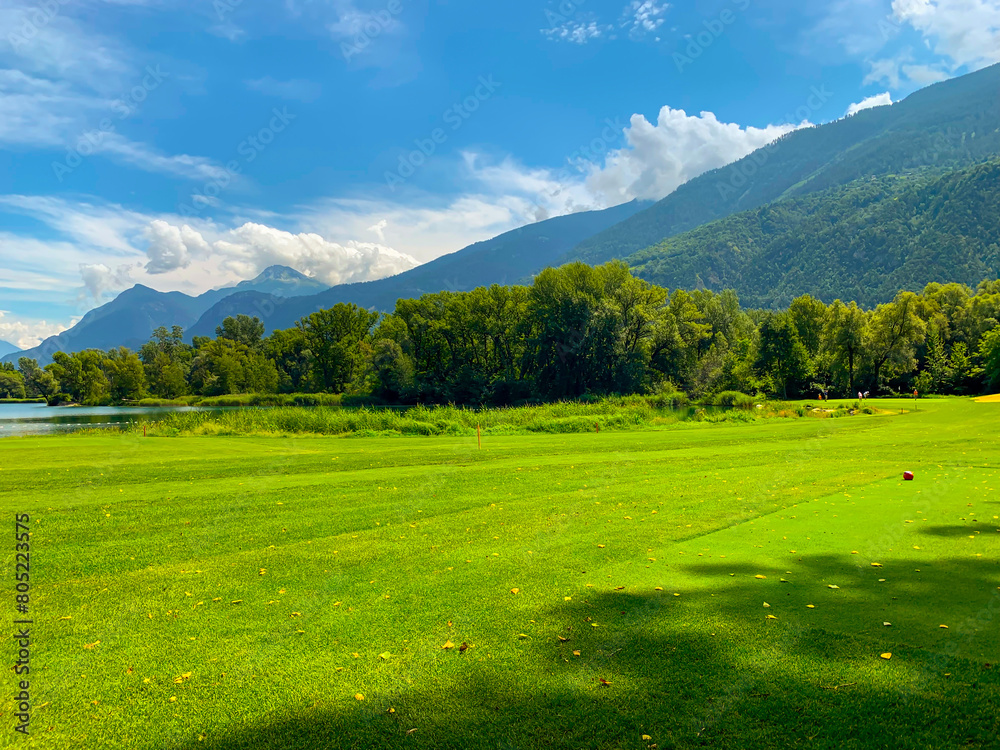 custom made wallpaper toronto digitalGolf Course with Mountain View and Clouds in a Sunny Summer Day in Granges, Valais in Switzerland.
