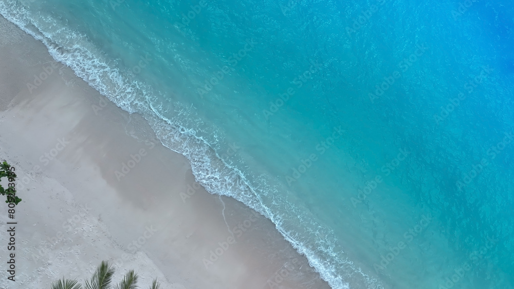 Ocean Tropical Beach with the soft wave water of the sea on the sandy beach background