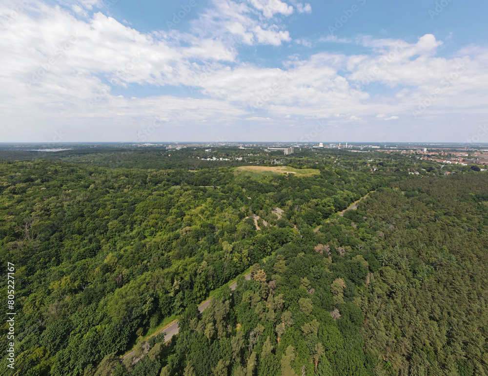 Aerial landscape of Drachenberg trash mountain in Grunewald forest on a sunny day in Berlin