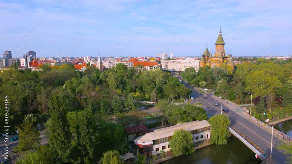 Aerial view of the beautiful city of Timisoara, Romania. Footage was shot from a drone from above the Bega river, with the Mitropolitan Cathedral and the city center in the view.