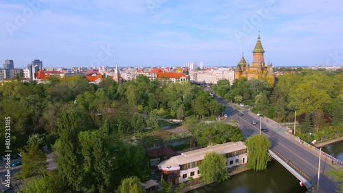 Aerial view of the beautiful city of Timisoara, Romania. Footage was shot from a drone from above the Bega river, with the Mitropolitan Cathedral and the city center in the view. photo