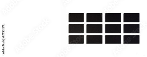 Mockup of horizontal Black business cards stacks arranged in rows at white textured paper background. Banner.