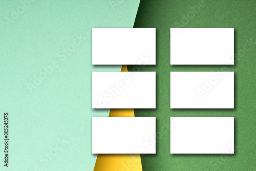 Business card blank over colorful background. Copy space for text. Top view.Business card blank over colorful abstract background. Corporate stationery branding mock-up. Copy space for text. Top view.