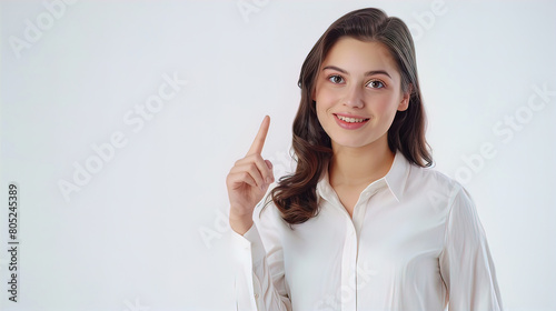 smiling pretty well-groomed young woman showing index finger up  isolated on white background  empty copy space