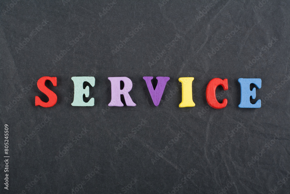 SERVICE word on black board background composed from colorful abc alphabet block wooden letters, copy space for ad text. Learning english concept. SERVICE word on black board background composed from colorful abc alphabet block wooden letters, copy space for ad text. Learning english concept.