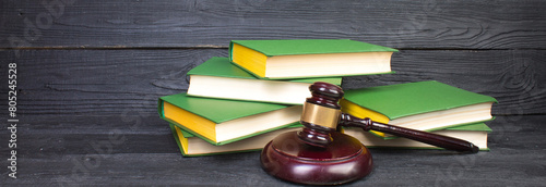 Law concept - Open law book with a wooden judges gavel on table in a courtroom or law enforcement office isolated on white background. panorama, banner.