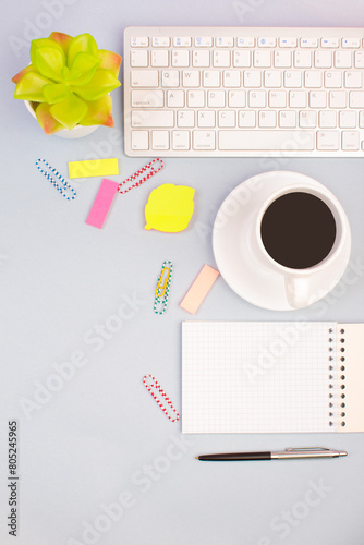 Tablet, calculator, phone, pen and a cup of coffee, lot of things on a light background. Top view with copy space.