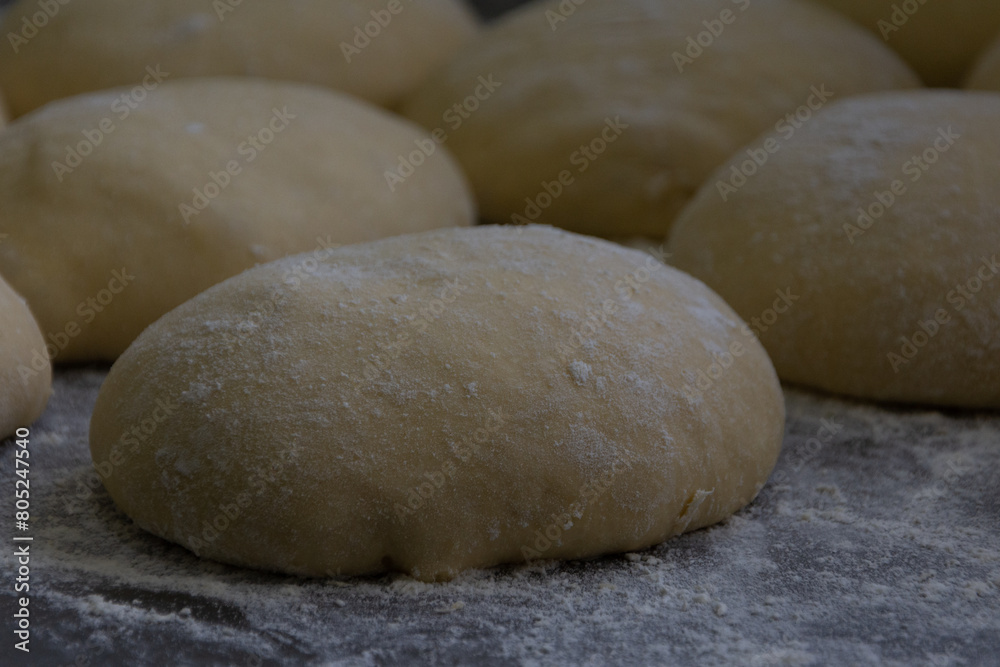 The process of making dough for sweet bread at home. Making buns with flour. The concept of baking bread The process of making dough for sweet bread at home. Making buns with flour. The concept of baking bread