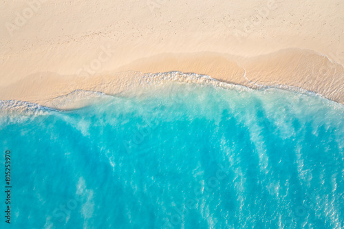 Summer seascape beautiful waves  blue sea water in sunny day. Top view from drone. Sea aerial surf  amazing tropical nature background. Mediterranean bright sea bay  waves splashing beach sandy coast