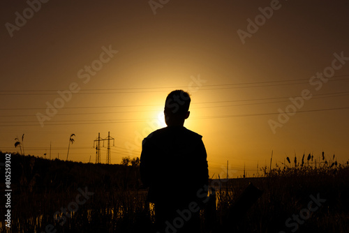 Silhouette of a little boy against a beautiful sunset