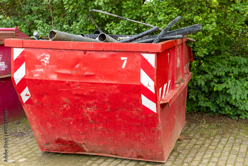 red container with construction waste