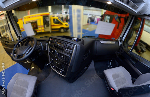 Interior of a truck cabin: seat, wheel, dashboard