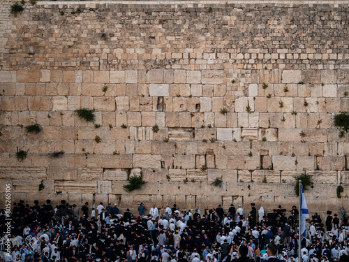 Jewish praying at the wailing wall in Jerusalem photo