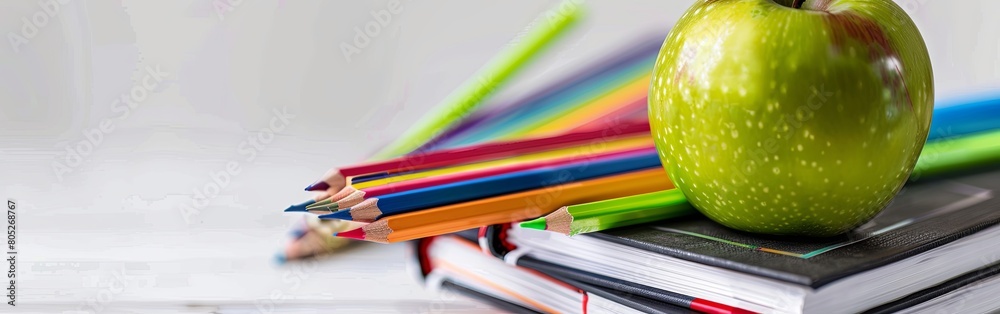 Green Apple and Books with School Supplies on White Background Green Apple and Books with School Supplies on White Background