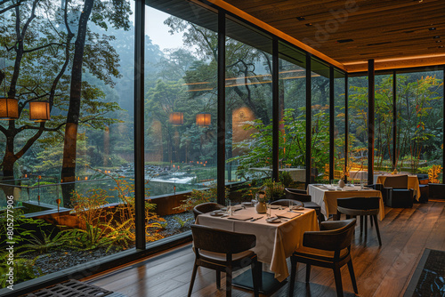 A modern hotel dining room adorned with minimalist furnishings and floor-to-ceiling glass windows  creating a seamless blend of indoor comfort and outdoor beauty.