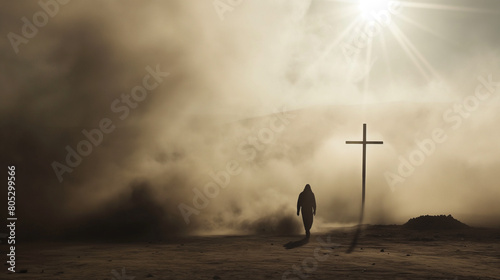 Silhouette of a man in the desert with a cross in the smoke and dust under light the sun, religion concept. 
 photo