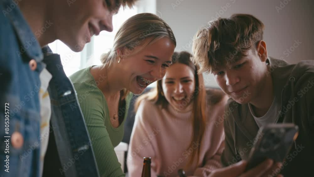 Group Of Teenage Friends At Home In Bedroom Looking At Social Media On Mobile Phone Drinking Alcohol Group Of Teenage Friends At Home In Bedroom Looking At Social Media On Mobile Phone Drinking Alcohol