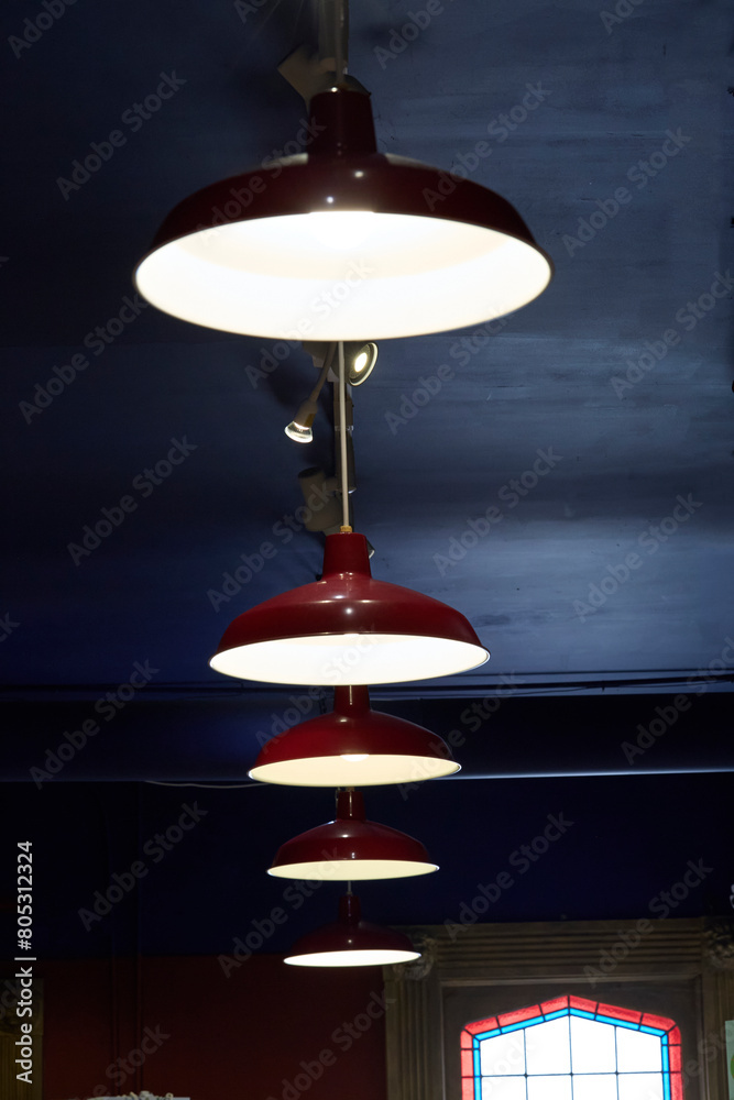 A Line of red hanging pendant lights. A Line of red hanging pendant lights.