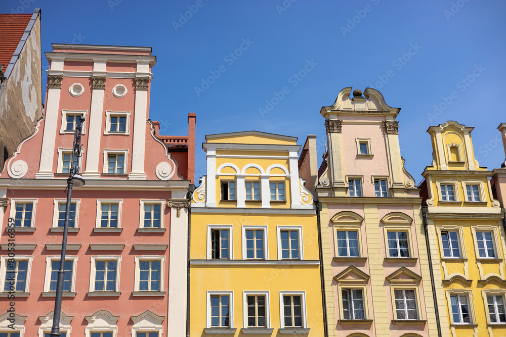 Fototapeta premium Beautiful colorful facades of antique building at Wroclaw, Poland. Polish landmark in the historic center of town. Clear blue sky