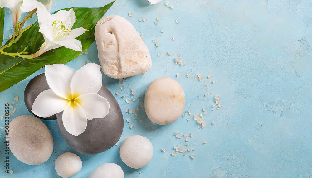 Spa concept on white and grey stone and flowers on blue background. Wellness and body treatment Spa concept on white and grey stone and flowers on blue background. Wellness and body treatment