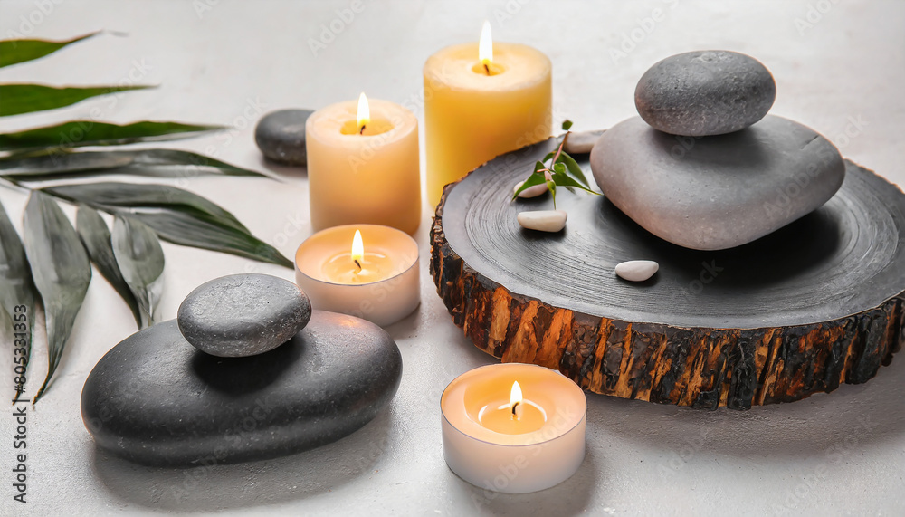 Zen pebbles and lightning candles. Stone spa, green leaves, healthcare. Wellness and body treatment