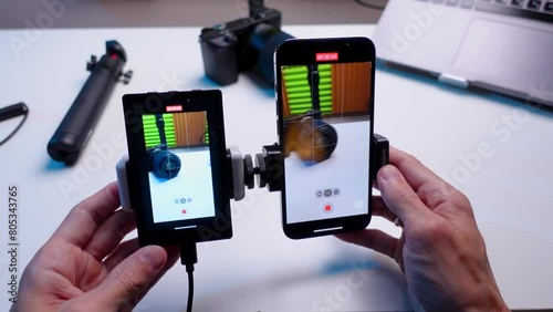 a tech blogger makes a video review on a smartphone and a screen broadcast display