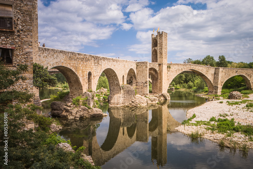 Reflections of Besalu: The Ancient Stone Bridge Amidst Nature’s Embrace photo