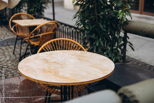 Outdoor street cafe tables ready for service. Modern Empty cafe terrace with table and chair, morning time. Food concept. Cafeteria, Outside Trattoria