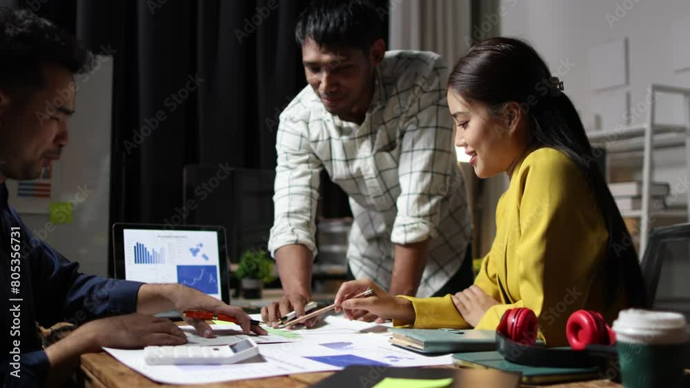 Coworkers working overtime at night in the office. Startup business discussion meeting is analyzing growth, marketing and finances. Strategy analysis and investment planning for new business projects.