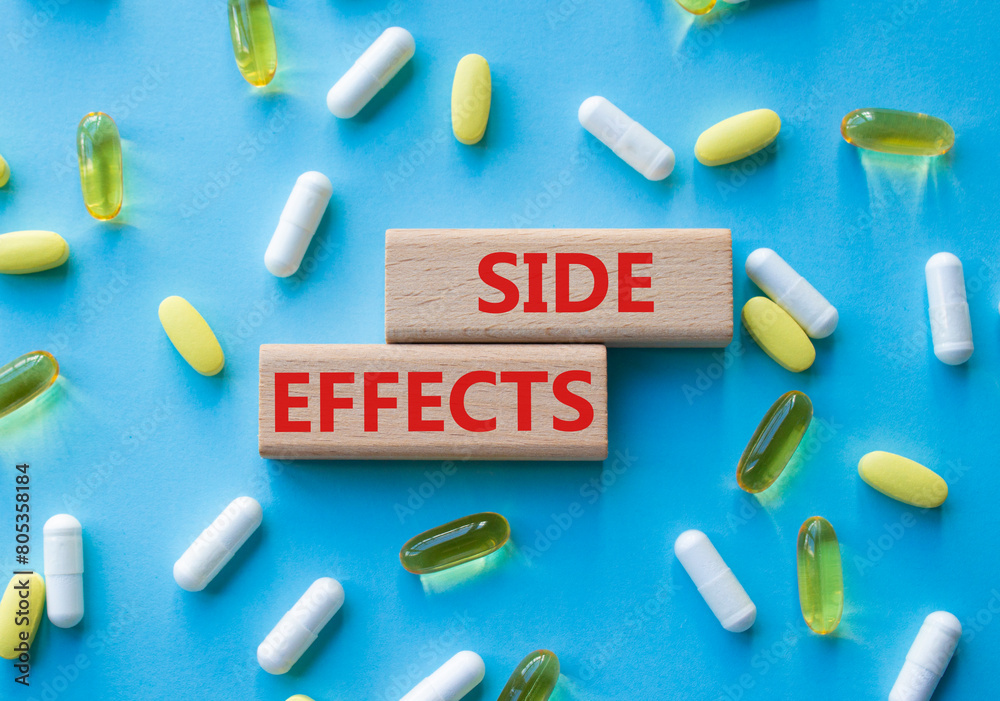 Side Effects symbol. Wooden blocks with words Side Effects. Beautiful blue background with pills. Medicine and Side Effects concept. Copy space. Side Effects symbol. Wooden blocks with words Side Effects. Beautiful blue background with pills. Medicine and Side Effects concept. Copy space.