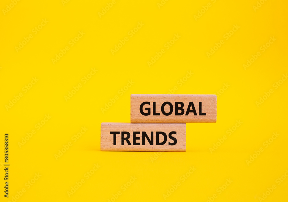 Global Trends symbol. Wooden blocks with words Global Trends. Beautiful yellow background. Business and Global Trends concept. Copy space. Global Trends symbol. Wooden blocks with words Global Trends. Beautiful yellow background. Business and Global Trends concept. Copy space.