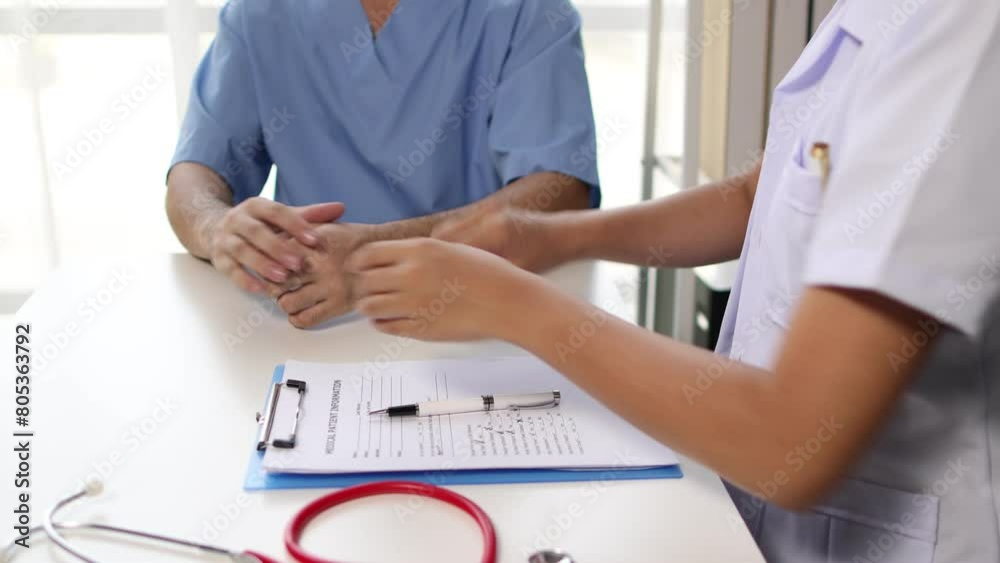 Female doctor is diagnosing pain in a male patient's wrist and arm in the examination room. Health consultant are providing treatment recommendations by hospital specialist. Female doctor is diagnosing pain in a male patient's wrist and arm in the examination room. Health consultant are providing treatment recommendations by hospital specialist.