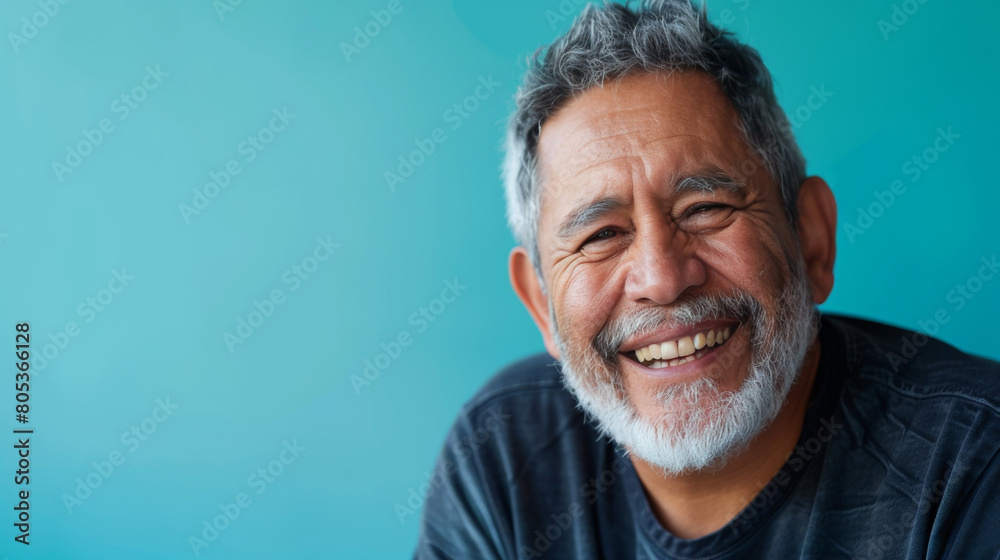 Obraz premium A man with a big smile on his face is posing for a picture