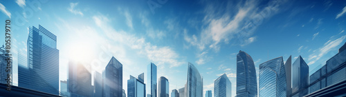 City Skyline at Sunrise with Reflective Skyscrapers and Light Clouds