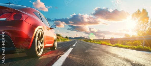 a red sports car is driving on the highway with beautiful natural views