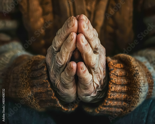 A moment of quiet reflection, captured in a close-up of hands clasped in prayer, seeking solace and guidance