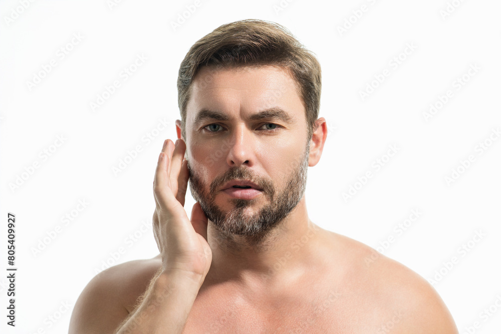 Obraz premium Beauty portrait of handsome man with moisturizing cream on face, isolated background. Skincare routine concept. Male haircut, mustache and beard. Male beauty. Shaving, hair styling.