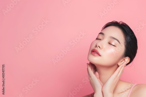 Portrait of a young asian woman over pink background, Copy Space. photo