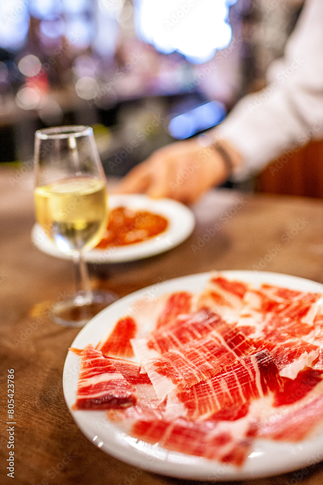 Fototapeta premium Glass of Fino and Iberian Ham at a Sevilla Tavern