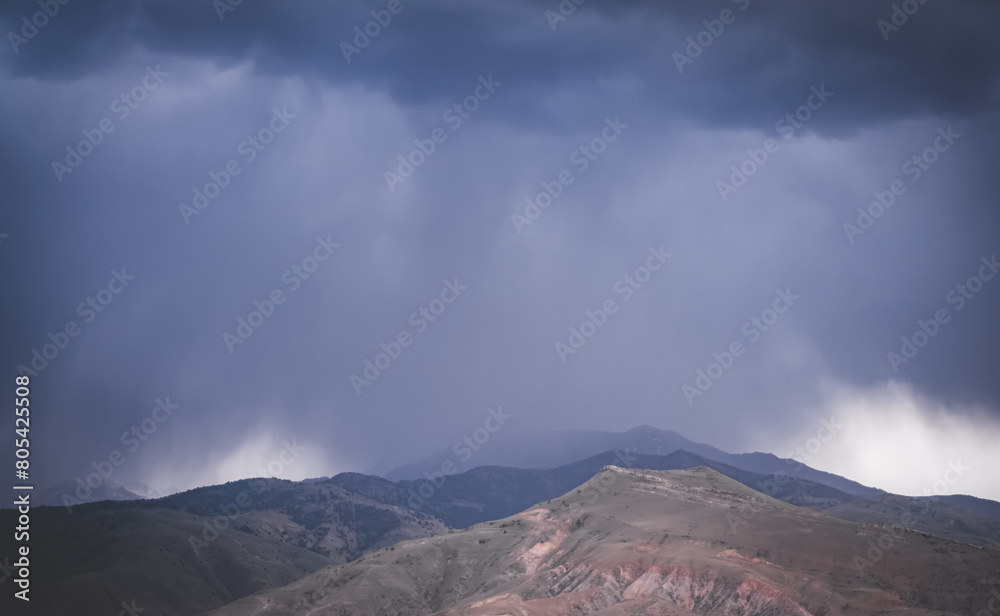 Cloudy rainy weather with clouds in the mountains, heavy rain and water pouring from the sky, rainy atmosphere