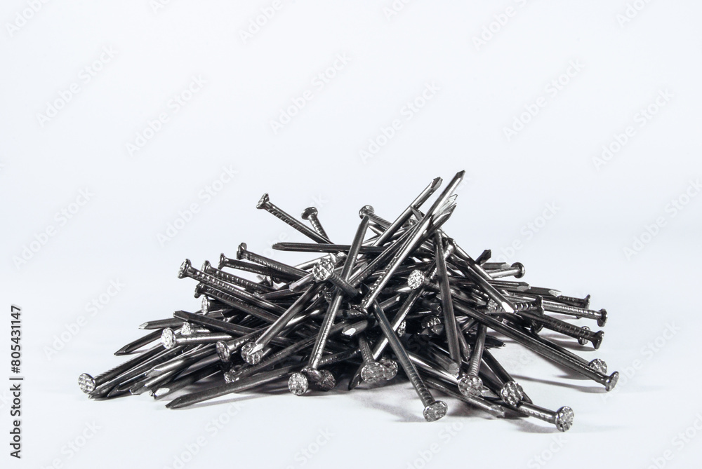 a pile of iron long nails on a white background a pile of iron long nails on a white background