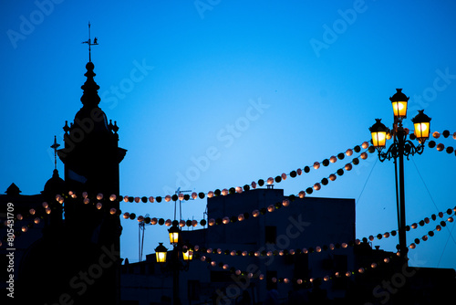 Paper lanterns on the Triana bridge for the Vela de Santa Ana festival, Seville, Spain photo