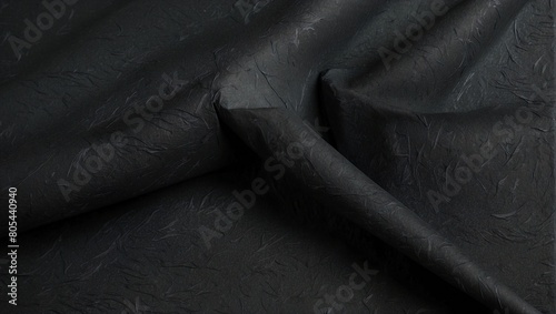 background texture of black paper with waves and folds