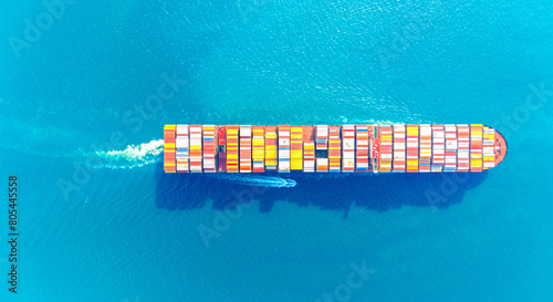 Top view Container ship full capacity approaching the port by a tugboat occupying the port International Container ship loading, unloading at sea port, Freight Transportation, Shipping, 